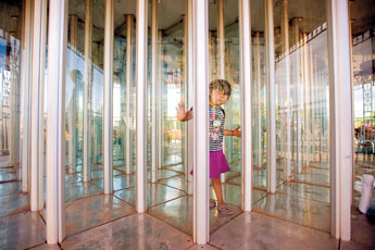 Four-year-old Alondra Bizahaloni tries to find her way through a mirror maze in a funhouse at the Navajo Nation Fair in Window Rock Thursday. © 2011 Gallup Independent / Cable Hoover 